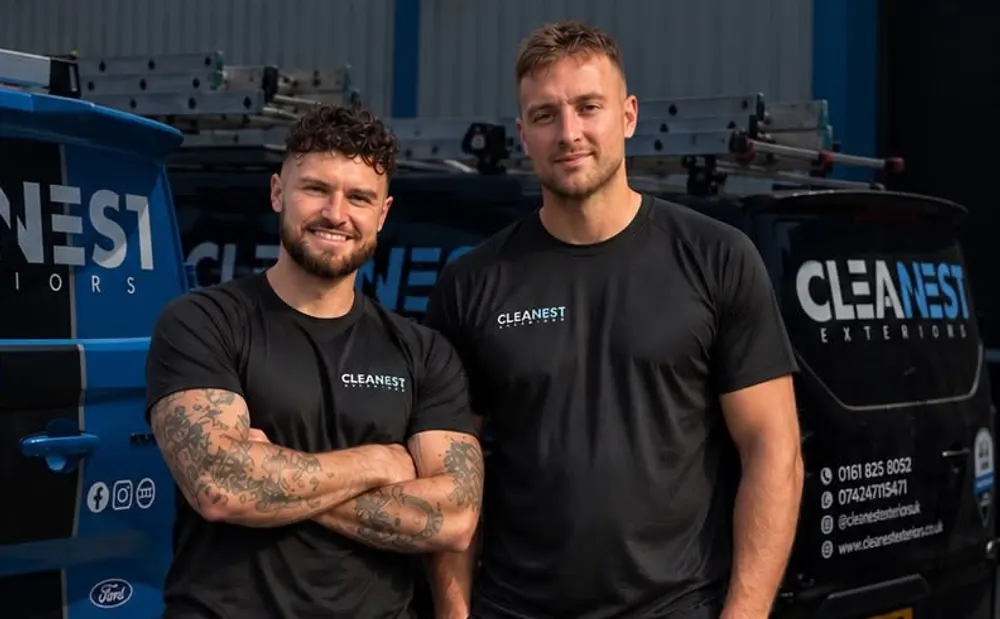 Matt and Bryn, co-founders of Cleanest Exteriors, in front of their branded vans