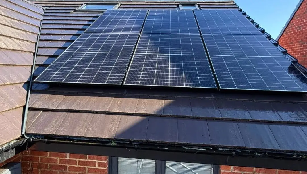 Tiled roof around solar panels after cleaning, moss cleared